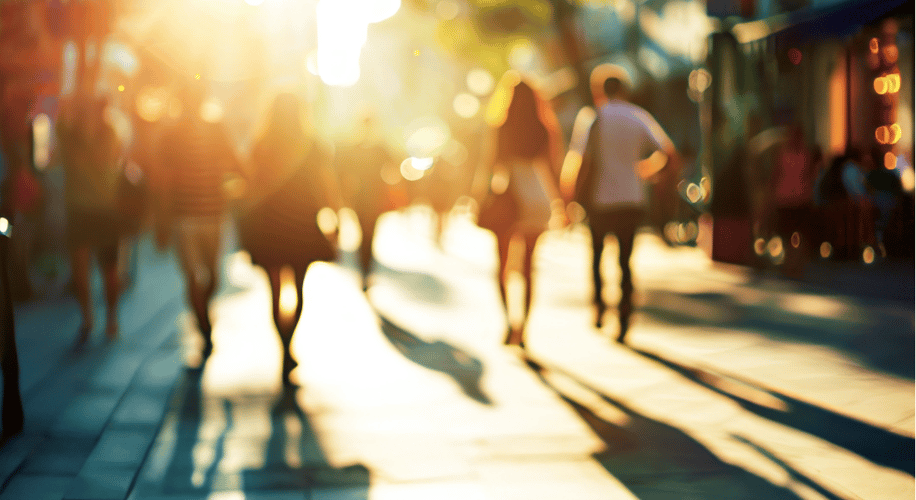 out of focus image of people walking down a city street