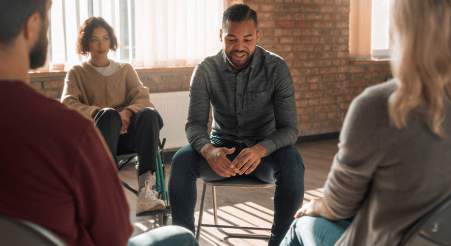 man sitting in a group therapy session