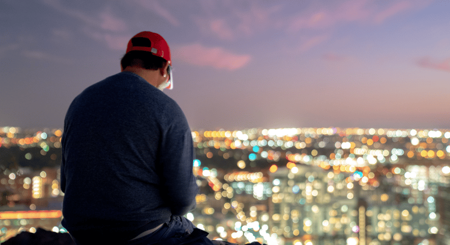 Man sitting and looking out over Tucson skyline