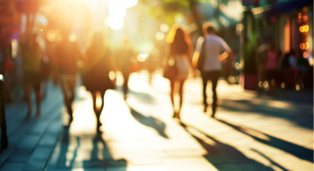 out of focus image of people walking down a city street